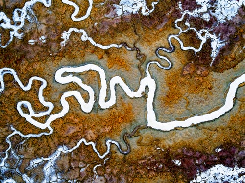 Preview: Aerial view of the landscape, meandering water channels and the salt pans with white salt and