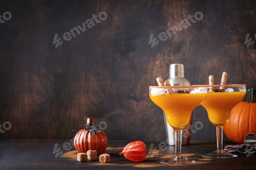 Preview: Pumpkin cocktail with cinnamon, orange juice and cocoa in glass mugs. Pumpkin autumn drink for Hallo