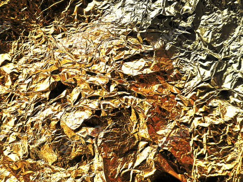 Preview: Close-up of the surface covered with gold-colored foil