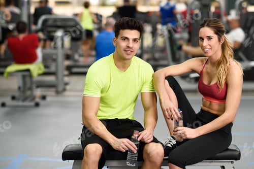 Preview: Man and woman drinking water after workout