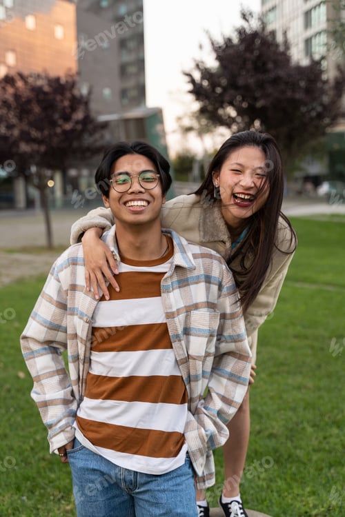 Preview: Asian teenager friends embracing and having fun together, wearing trendy clothes