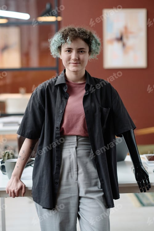 Preview: Female Office Worker with Prosthetic Arm Posing at Her Workplace
