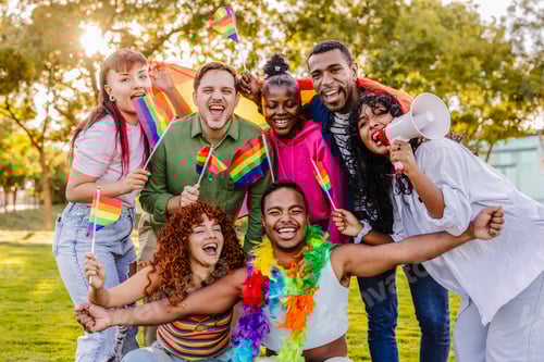 Preview: Diverse group celebrating lgbtq plus pride with rainbow flags