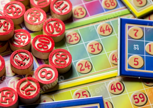 Preview: Colorful bingo game cards and numbers on white background, close up, isolated.