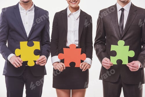 Business Team Holding Colorful Puzzle Pieces Together