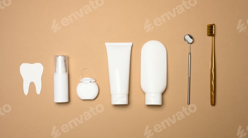 Preview: Toothbrush, toothpaste and paper tooth on a brown background, oral hygiene.