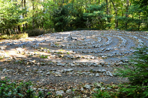 Preview: A stone labyrinth in the woods for mediation or spiritual activities with a cairn in the middle