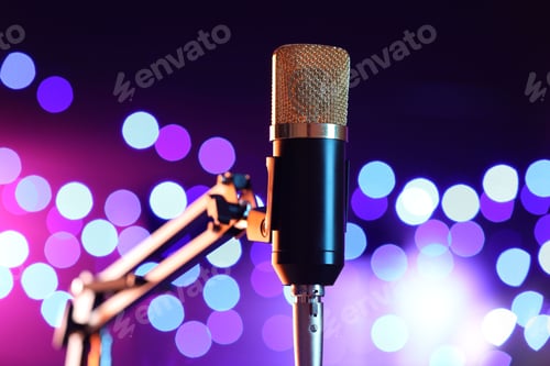 Preview: Microphone on stand against color background with blurred lights. Bokeh effect