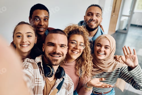 Preview: Multi-ethnic group of happy college friends taking selfie in a hallway.