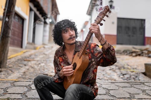 Preview: A young Mexican musician is playing jarana guitar in the street