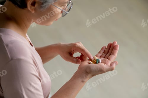 Preview: Senior woman taking medicine