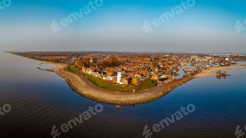 Preview: Urk Flevoland Netherlands sunset at the lighthouse and harbor of Urk Holland. Fishing village Urk