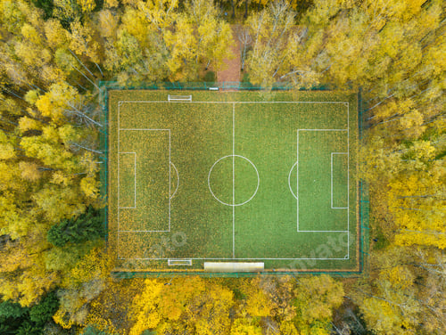 Preview: Football pitch surrounded by autumn yellow forest