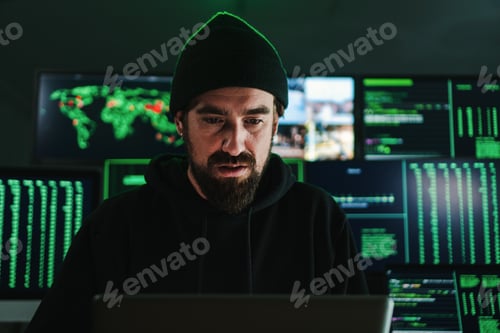Preview: One criminal hacker man programming a phishing virus, at background a lot of data screens. One