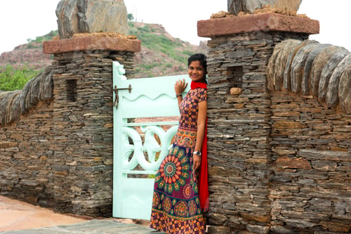 Preview: Woman in front of old stone wall