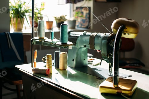 Preview: Sewing machine on table in factory in sun light. Small business, fashion designe, Tailor working