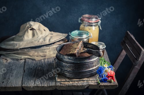Preview: Vintage beekeeper tools in workshop with honey