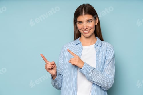 Preview: Happy positive woman pointing index fingers aside on copy space