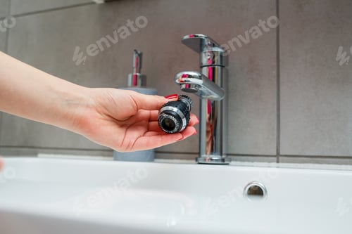 Preview: Rotary nozzle on the mixer to adjust the flow of water. White bathroom sink for washing hands