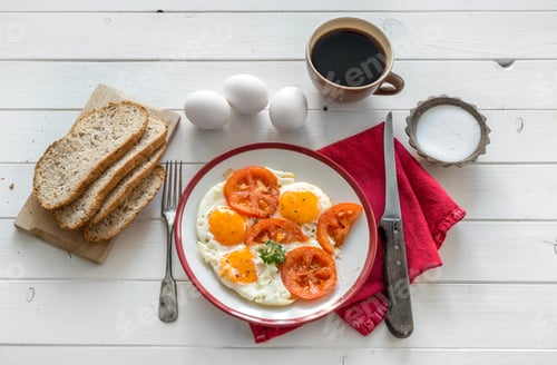 Preview: Eggs fried overeasy served on white plate