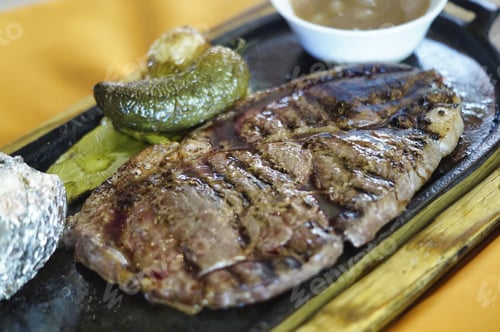 Preview: Closeup of steaks with beans, jalapeno, nopal, and roasted potato