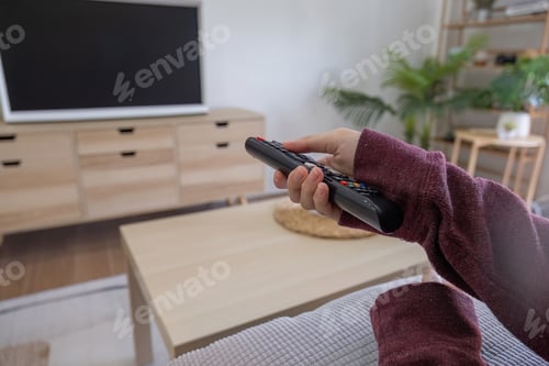 Preview: Young beautiful Asian woman is watching a fun movie on television at home. Attractive casual girl