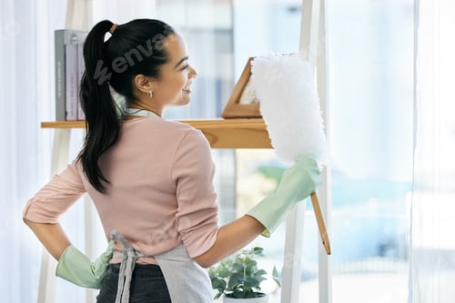 Preview: I love a fresh and clean house. Shot of a woman holding a duster while doing chores at home.