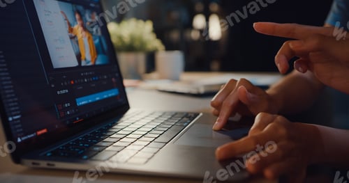 Preview: Young Asia ladies blogger watching footage on laptop sharing ideas with friend.
