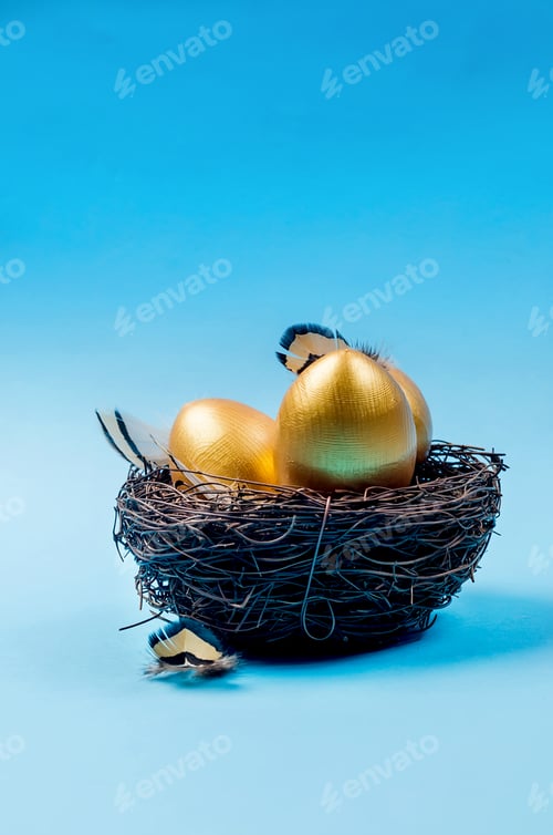 Preview: Easter gold decorative eggs in the nest on blue