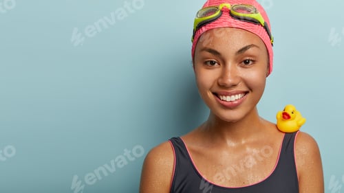 Preview: Cropped shot of attractive happy lady has wet body, charming smile, shows white perfect teeth, dives