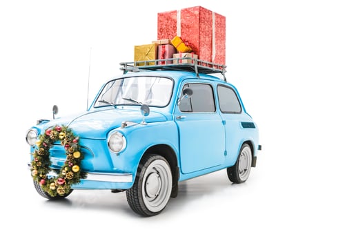 Preview: blue old car with christmas wreath and gifts on roof isolated on white