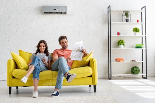 Preview: Couple Relaxing Together on Sofa in Living Room