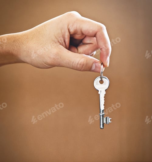 Preview: Cropped shot of an unrecognizable mans hand holding the key to his new home