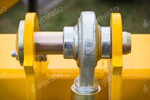 Preview: Screws and bolts as part of yellow agricultural machinery. Technology