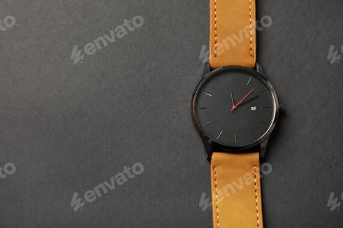 Preview: Stylish wrist watch on dark background, top view with space for text. Fashion accessory