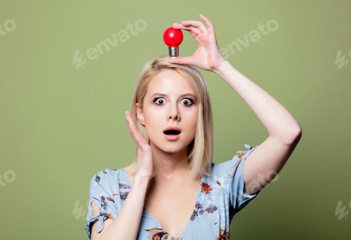 Preview: Blonde woman wiith red boulb on green background