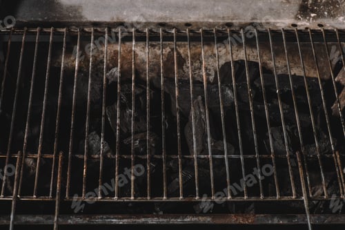 Preview: dark black natural coals under iron bbq grid