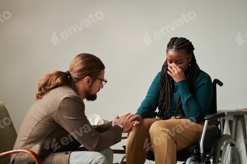 Preview: Therapist supporting patient with disability