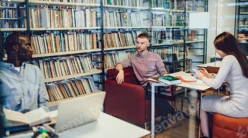 Preview: Coworkers speaking and using gadgets in library