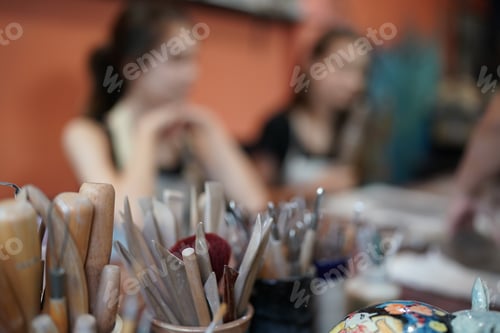 Preview: Young Woman hand potter making clay vase in pottery workshop, Business owner.