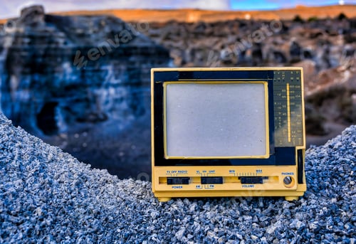 Preview: Closeup shot of an old vintage radio TV on a rock on a blurred background