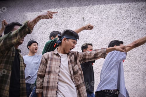 Preview: Group of Protesters With Their Arms Raised During Demonstration March on The Road
