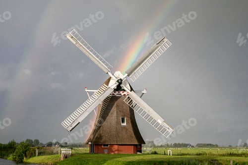 Preview: rainbow and Dutch windmill in summer