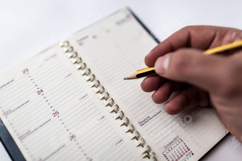 Preview: writing on an agenda with a pencil
