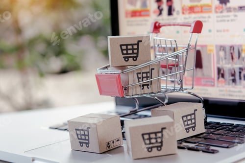 Preview: cardboard box with a shopping cart logo in a trolley on laptop keyboard