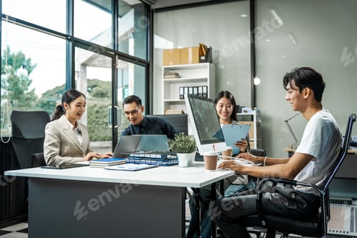 Preview: Asian colleagues meet at a desk, discussing business financial terms, investment strategies
