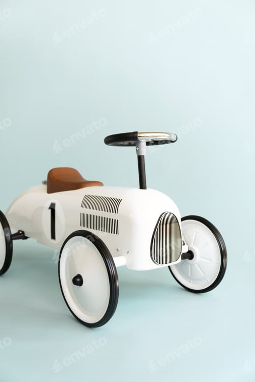 Preview: Retro style beige toy car on blue background. Stylish toy for toddler boy.