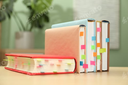 Preview: Books with colorful tabs on wooden table indoors