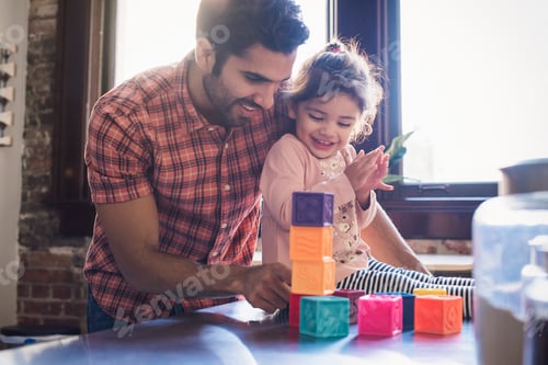 Preview: Father and daughter playing with building bricks
