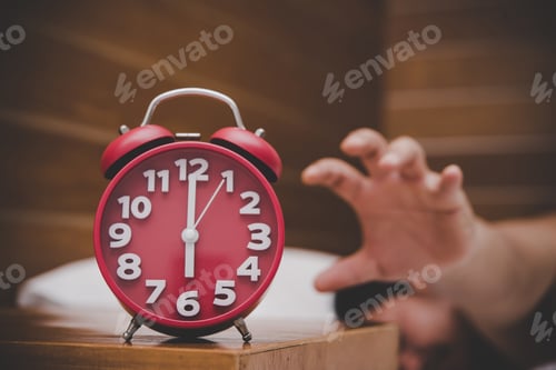 Vista previa: Man being awakened by an alarm clock in his bedroom.